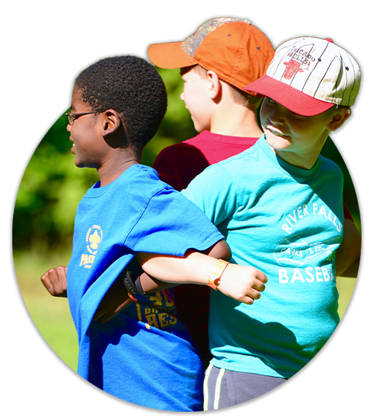 Three young boys have their arms locked as they complete a team-building game